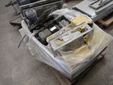 a pile of electronics sitting on a pallet in a warehouse