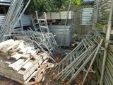 a pile of wood sitting on the ground in front of a building