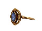 an image of a gold ring with a blue stone in the center