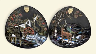 two decorative plates with a picture of a man and a horse
