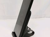 a cell phone that is on a stand on a table