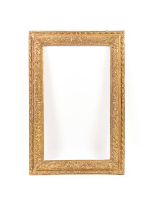a gold framed mirror against a white wall