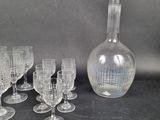 a lot of wine glasses and a decanter on the table