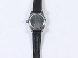 a close up of a watch on a white surface with a white background