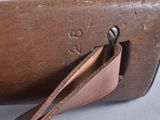 a brown case that has a leather strap on it