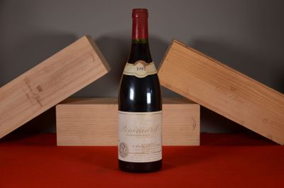 a bottle of wine sitting on a table next to two wooden boxes