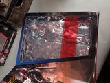 a box of action figures on a table next to a box of action figures