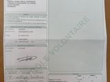 a close up of a receipt on a table with a pen