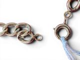 a close up of a chain with a tassel on it