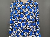 a blue and white floral blouse on a mannequin mannequin