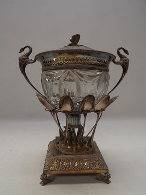 a silver and glass vase with a bird on it