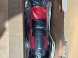 a red toy car in a box on the floor