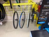 three bikes that are hanging on a rack in the garage