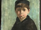portrait of a young boy in a black coat and hat