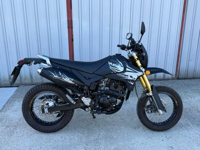 une photo d'une moto garée devant un immeuble