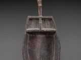 an old wooden boat with a wooden handle on a gray background