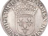 a close up of a silver coin with a crown on it