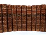 the books are lined up in a row on a white surface