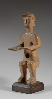 an image of a wooden statue of a man holding a knife