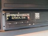 a radio in the center of a car with a qr code on it