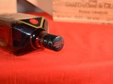 a bottle of wine sitting on a table next to a box of wine