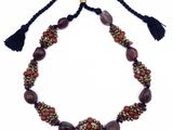 un collier orné de perles et de pompons sur fond blanc