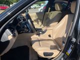 the interior of a car with the door open and the driver ' s seat down