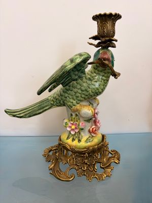 a bird that is sitting on top of a vase