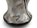 a vase that has a black and white design on it