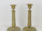 pair of antique brass candlesticks on a white background