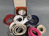 a lot of belts that are sitting on a table