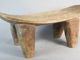 a small wooden bench that is sitting on a white surface