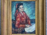 painting of a woman reading a book in a gold frame