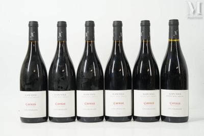 six bottles of wine are lined up in a row on a white surface