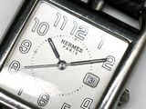 a close up of a watch on a white surface