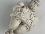 a small figurine of a man holding a baby