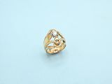 a close up of a gold ring on a white surface