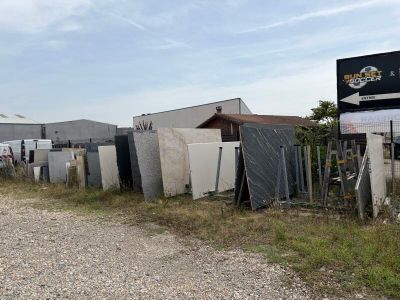 a lot of old refrigerators and other appliances on the side of the road