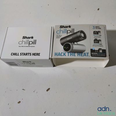 packaging of a black and white camera sitting on top of a white table