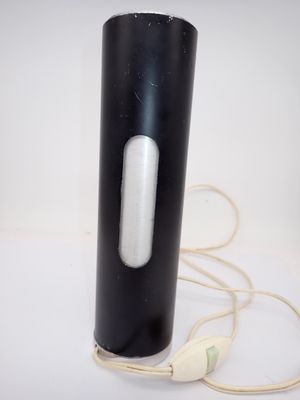 an image of a black and white vase with a cord