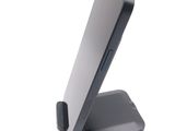 a cell phone on a stand on a white surface