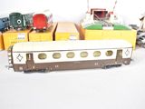 several toy trains are lined up next to each other on a white surface