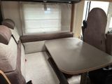 a couch and a table in the back of a camper