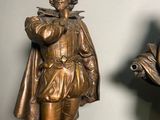 two bronze statues of a man and a woman standing next to each other