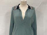 sweater on a mannequin stand with a white background