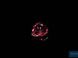 a close up of a red diamond on a black background