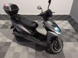 a scooter that is parked on a checkered floor