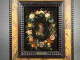 painting of a woman in a wreath of flowers in a black frame