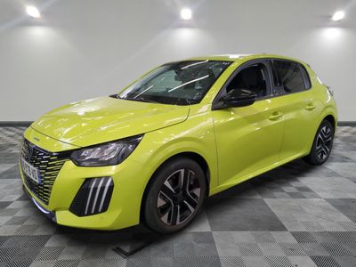 a bright yellow car is parked in a room with checkered floor