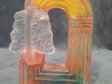 a glass sculpture of a rainbow and a cloud